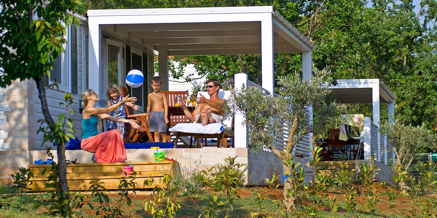 Gezin ontspant op de veranda van een Istrian Home op Camping Lanterna